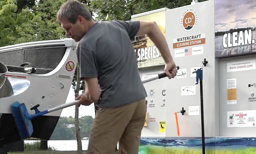 Man using boat decontamination station to stop the spread of aquatic invasive species. 