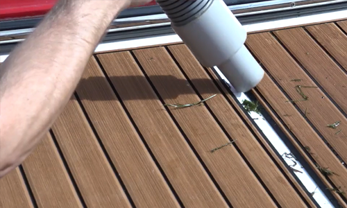 Man using boat decontamination station to clean boat trailer to stop the spread of aquatic invasive species. 